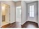 Hallway with hardwood floors leading to rooms with neutral paint and carpeted floors at 104 Wild Orchid Way, Huger, SC 29450
