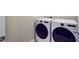 Laundry room with modern front load washer and dryer set against a neutral wall at 104 Wild Orchid Way, Huger, SC 29450