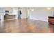 Open-concept living area featuring hardwood floors and a view into the modern kitchen at 104 Wild Orchid Way, Huger, SC 29450