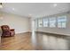Spacious living room with hardwood floors, plenty of natural light, and a leather chair at 104 Wild Orchid Way, Huger, SC 29450