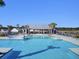 Resort-style pool with sundeck and shade, enhancing outdoor relaxation and recreation at 104 Wild Orchid Way, Huger, SC 29450