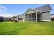 Backyard with a screened-in porch, adjacent to the lawn, providing a relaxing view and outdoor living space at 107 Cotton Blossom Way, Summerville, SC 29485