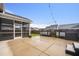 Spacious backyard featuring a patio, screened-in porch, and a well-manicured lawn, great for outdoor activities at 107 Cotton Blossom Way, Summerville, SC 29485
