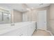 Bright bathroom featuring a dual sink vanity with white cabinets, a large mirror, and tile flooring at 107 Cotton Blossom Way, Summerville, SC 29485