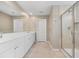 Bright bathroom featuring a dual sink vanity with white cabinets and a glass-enclosed shower at 107 Cotton Blossom Way, Summerville, SC 29485