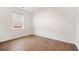 Empty room with hardwood floors and a window with horizontal blinds offering natural light and privacy at 107 Cotton Blossom Way, Summerville, SC 29485