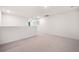 A spacious bonus room features neutral walls and carpet with natural light, ideal for entertainment or relaxation at 107 Cotton Blossom Way, Summerville, SC 29485