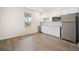 Bright kitchen featuring white cabinets, stainless steel appliances, and hardwood floors at 107 Cotton Blossom Way, Summerville, SC 29485