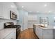 Modern kitchen with stainless appliances, white cabinets, subway backsplash, quartz countertops and gas range at 107 Cotton Blossom Way, Summerville, SC 29485
