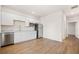 Bright kitchen features white cabinets, stainless steel appliances, and hardwood floors for a clean and modern look at 107 Cotton Blossom Way, Summerville, SC 29485