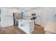 Bright, open kitchen with stainless appliances, white cabinetry, countertop and center island with a sink at 107 Cotton Blossom Way, Summerville, SC 29485