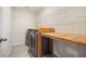 Well-organized laundry room featuring modern washer/dryer and a wooden countertop for folding or storage, maximizing efficiency at 107 Cotton Blossom Way, Summerville, SC 29485
