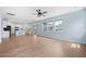 Spacious living room open to kitchen, with hardwood floors and bright light from the large windows at 107 Cotton Blossom Way, Summerville, SC 29485