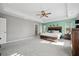 Spacious main bedroom features tray ceiling, ceiling fan, carpet, and modern decor, combining style and comfort at 107 Cotton Blossom Way, Summerville, SC 29485