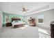 Spacious main bedroom with tray ceiling, ceiling fan, carpet, and furnishings, combining style and functionality at 107 Cotton Blossom Way, Summerville, SC 29485