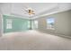 Large main bedroom featuring a tray ceiling, neutral carpet, and natural light, creating a peaceful and inviting retreat at 107 Cotton Blossom Way, Summerville, SC 29485