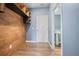 A mudroom with wood accent wall, shelves, and an entryway to a bathroom, showcasing functionality and style at 107 Cotton Blossom Way, Summerville, SC 29485