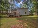 View of the home's backyard, deck and landscaping from the lawn at 109 Evance Ct, Summerville, SC 29485