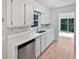 Bright kitchen featuring sleek countertops, stainless steel dishwasher, and hardwood flooring at 109 Evance Ct, Summerville, SC 29485