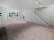 Open living space with carpet and staircase featuring seamless flow and neutral palette at 109 Evance Ct, Summerville, SC 29485