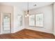 Bright dining area with wood floors, contemporary lighting, and access to outdoor space at 112 Mayfield Dr, Goose Creek, SC 29445