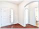 Bright foyer featuring hardwood floors, white trim, and arched doorway leading to a bathroom at 112 Mayfield Dr, Goose Creek, SC 29445
