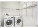 Convenient laundry room with modern washer and dryer, plus wire shelving for organized storage at 112 Mayfield Dr, Goose Creek, SC 29445