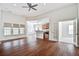Open concept living room with wood floors flowing into a modern kitchen with stainless steel appliances at 112 Mayfield Dr, Goose Creek, SC 29445