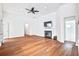 Spacious living room with hardwood floors, fireplace, and seamless flow to adjacent rooms at 112 Mayfield Dr, Goose Creek, SC 29445