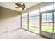 Enclosed patio features a ceiling fan and sliding glass doors leading to a grassy backyard at 112 Mayfield Dr, Goose Creek, SC 29445