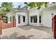 Paver patio with white brick home with large windows and door, offering a beautiful space for relaxation and enjoyment at 115 Old Postern Rd, Summerville, SC 29483
