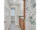 This hallway bathroom boasts floral wallpaper and tile flooring with a vanity at 115 Old Postern Rd, Summerville, SC 29483