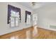 Bright bedroom with hardwood floors, shuttered windows, and ornate window dressings at 115 Old Postern Rd, Summerville, SC 29483