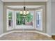 Charming breakfast nook with large windows offering scenic backyard views and a decorative chandelier at 115 Old Postern Rd, Summerville, SC 29483