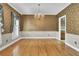 Elegant dining room featuring hardwood floors, chair rail, and stylish chandelier at 115 Old Postern Rd, Summerville, SC 29483