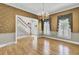 Bright dining room showcasing hardwood floors, chair rail, and staircase access at 115 Old Postern Rd, Summerville, SC 29483