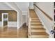 Inviting entryway with hardwood floors, staircase, and views into adjacent rooms at 115 Old Postern Rd, Summerville, SC 29483