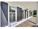 Detailed view of home exterior with brick flooring, black shutters and white paint at 115 Old Postern Rd, Summerville, SC 29483