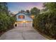 Charming white brick home with a two-car garage at dusk at 115 Old Postern Rd, Summerville, SC 29483