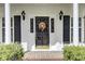 Close-up of the front door showcasing its design, black shutters and surrounding landscape at 115 Old Postern Rd, Summerville, SC 29483