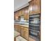 Traditional kitchen featuring wood cabinets, granite countertops, and double oven at 115 Old Postern Rd, Summerville, SC 29483