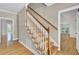 Hardwood staircase with white posts and wooden rails, leading to a bright living space at 115 Old Postern Rd, Summerville, SC 29483