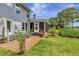 Landscaped backyard featuring a brick patio, screened porch, and lush green lawn at 1199 Parkway Drive, Mount Pleasant, SC 29464