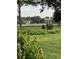 Well-manicured backyard with manicured lawn, a bird feeder and lush greenery enhances the property at 1199 Parkway Drive, Mount Pleasant, SC 29464