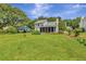 Spacious backyard showcasing a screened-in porch and mature trees on a sunny day at 1199 Parkway Drive, Mount Pleasant, SC 29464
