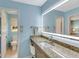 Light blue bathroom with a granite countertop, stylish sink, and a modern, lighted mirror at 1199 Parkway Drive, Mount Pleasant, SC 29464