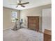 Bedroom with exercise bike, wooden dresser, gray carpet, ceiling fan, and window bringing in sunlight at 1199 Parkway Drive, Mount Pleasant, SC 29464
