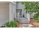 Inviting front porch with gray stairs and white rails, complemented by lush greenery at 1199 Parkway Drive, Mount Pleasant, SC 29464