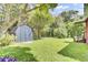 Spacious backyard with a storage shed, lush lawn and landscaping at 1237 Fort Dr, Hanahan, SC 29410
