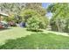 Lush backyard featuring green grass and mature shade trees in the summer at 1237 Fort Dr, Hanahan, SC 29410